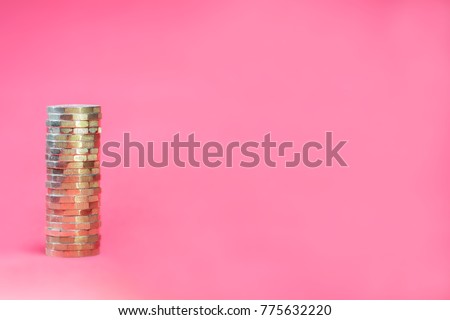 Stacked Pound Coins on Pink Background with Negative Space for Copy / Advert Royalty-Free Stock Photo #775632220
