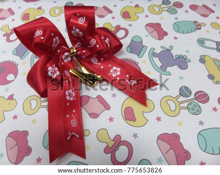 Handmade red ribbon decorate on the gift box which wrap with a cute paper for new year festival