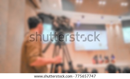 Abstract blurred photo of Cameraman and people background in the big meeting or conference room for a background, Conference meeting concept.