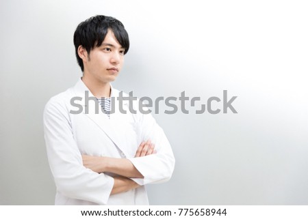 Male in white coat with arms (doctor, scientist, scholar)