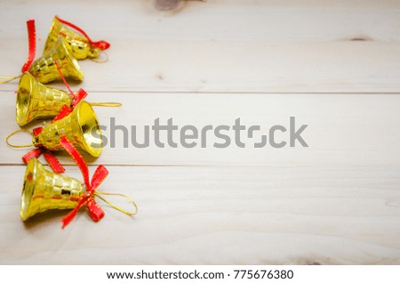 Christmas Decorations, Golden bells wood background.The concept of Xmas celebration,season greeting.Copy space with Selective focus.