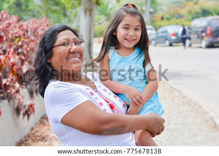 Happy latin mom and little daughter outside.  Royalty-Free Stock Photo #775678138