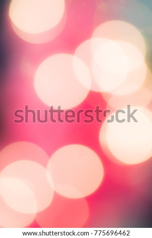 Colorful festive bokeh background, intentional out of focus bright circles of light. A fun vertical background for text and copy. A seasonal and holiday explosion of vibrancy. 
