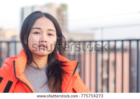 A beautiful asian girl smiling in the winter terrace