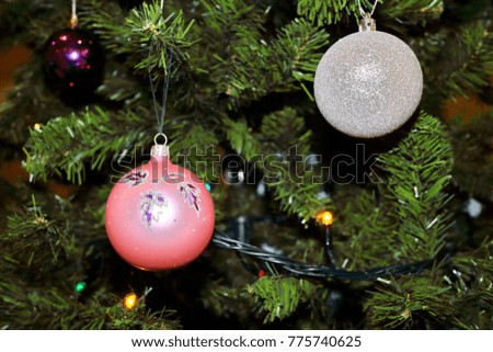 presents for christmas, red, white and glass balls on the background of a green Christmas tree