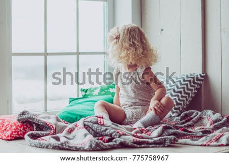 Little cute baby curly girl, toddler daughter in christmas and happy new year decorations