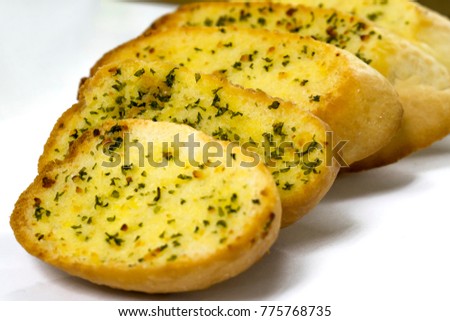 garlic bread slices ,isolated on white back ground. shallow depth of field images. Royalty-Free Stock Photo #775768735