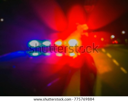 Police car lights in night time, crime scene. Night patrolling the city. Abstract blurry image.
