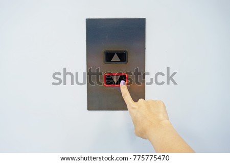 Woman's hand pushing the elevator button 