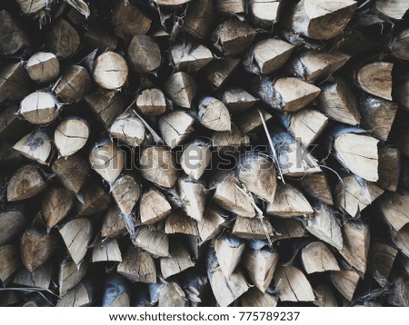 Abstract photo of a pile of natural wooden logs background dry chopped firewood logs ready for winter