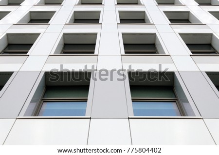 Perspective view of the modern gray building facade with windows