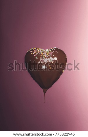 chocolate heart shaped candy with glaze isolated on pink