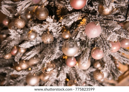 Decorated Christmas tree. New Year's decorations. Decoration of the house. Christmas tree with white golden and pink balls. Place for text