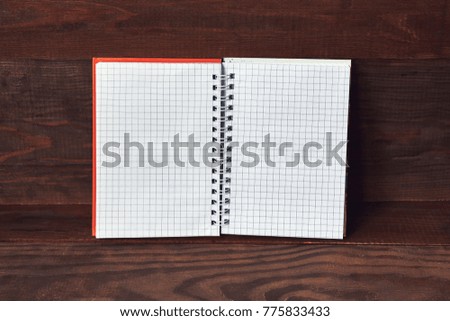 Blank notepad on a wooden surface.
