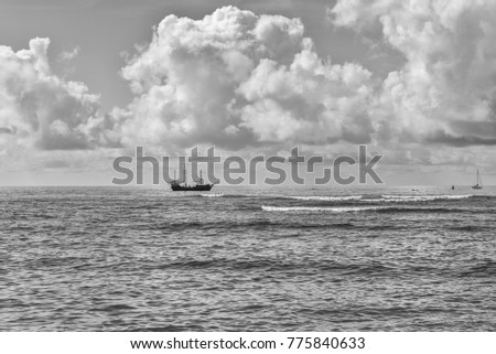 Honolulu, Hawaii, USA, Dec.  17, 2017.  Waikiki Winter morning at Ala Moana Surfing Beach as a galleon sailing ship passes close by the surfers.