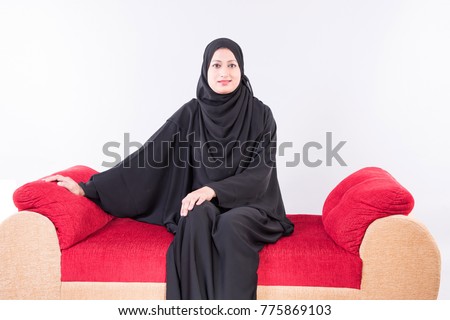 Arab woman sitting on sofa chair relaxing