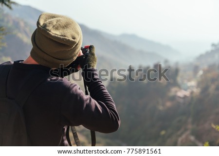 Man take a photo in mountains.