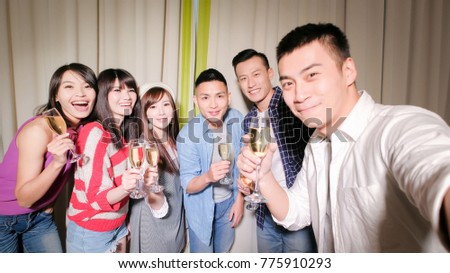 young people take champagne and selfie happily with party