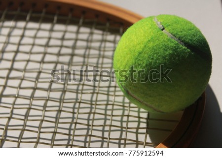 Tennis Ball and wooden racket 