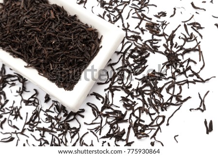 Beautiful and delicious dried tea leaves with herbs, flowers, berries, fruits, coconut slices, cocoa and coffee chips. Detailed studio shoot with selective focus and abstract blurred background