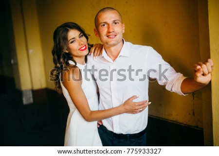 Young couple taking pictures in the street