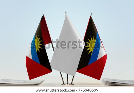 Two flags of Antigua and Barbuda with a white flag in the middle