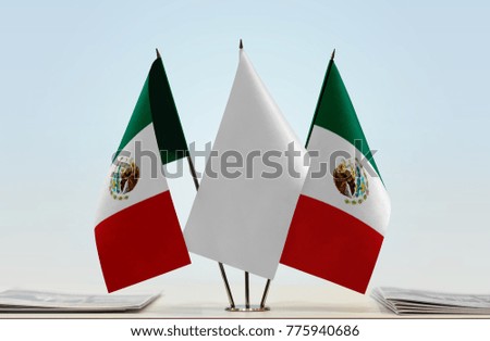 Two flags of Mexico with a white flag in the middle