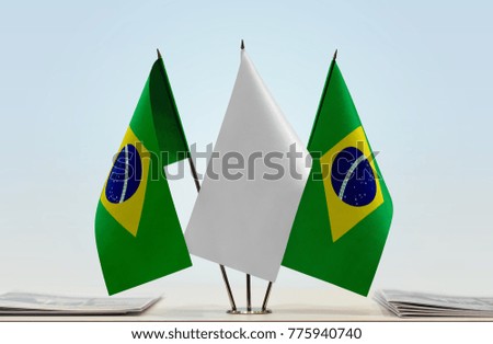 Two flags of Brazil with a white flag in the middle