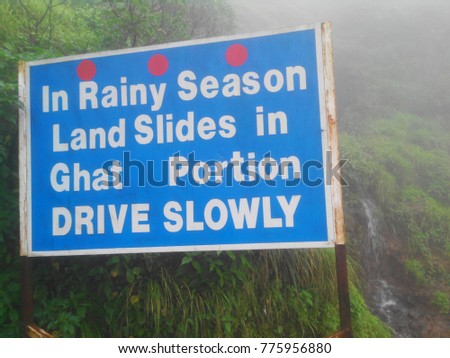 Sigh board, Caution, In rainy season land slides in Ghat portion DRIVE SLOWLY