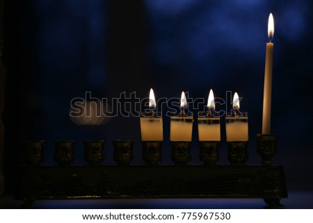 Ignition Chanukah candles in celebration of Hanukkah