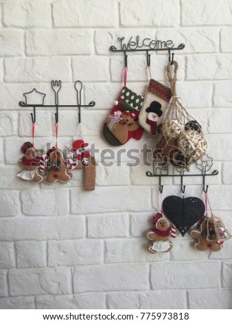 small knitted socks on a rope Christmas cookie decoration on wall background