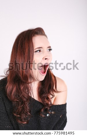young woman yawning white background