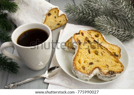 Coffee and traditional stollen on the grey wooden background