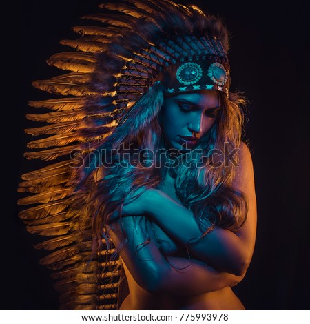 Shaman beautiful girl with plume of american indian feathers