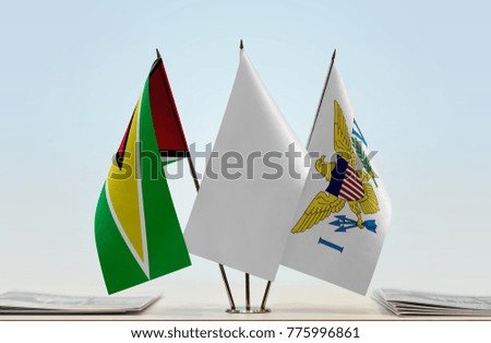 Flags of Guyana and U.S. Virgin Islands with a white flag in the middle