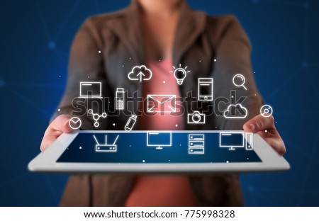 Casual young woman holding tablet with multimedia icons 