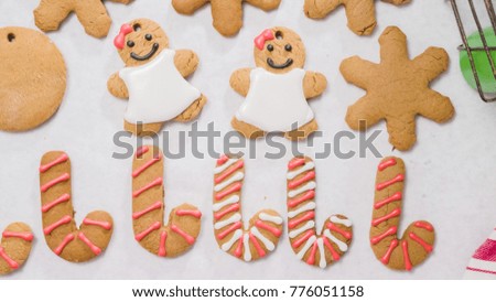 Decorating gingerbread cookies with royal icing for Christmas.