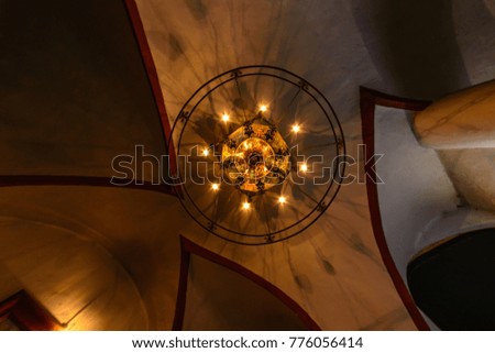 The old chandelier in the castle on the ceiling