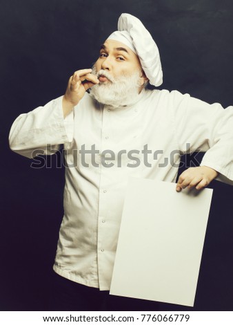 Grimace cook holding blank paper on grey background, copy space
