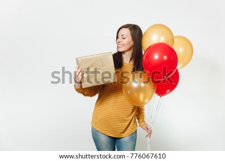 Beautiful caucasian fun young happy woman in yellow clothes, holding birthday red balloons, golden gift boxes with present, celebrating holiday party on white background isolated for advertisement