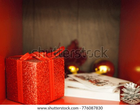 The decorate items of Christmas in the red box that was red gift box,greeting card,golden ball