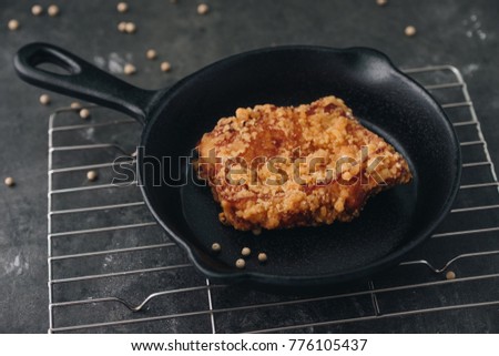 Chicken karaage japanese food in the pan on grey concrete background with herb and flour
