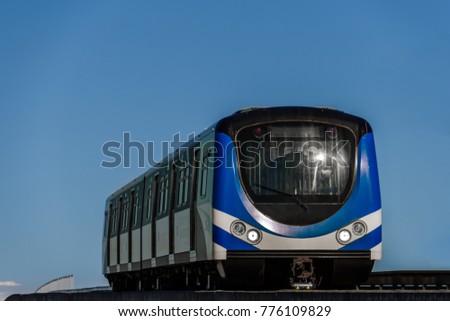 modern blue train carriage on the sky background, bottom view