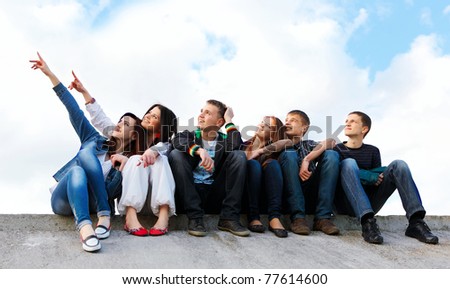 happy group of friends smiling outdoors Royalty-Free Stock Photo #77614600