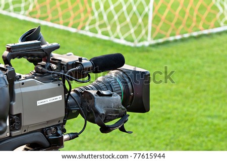 video camera put on the back of football goal for broadcast on TV sport channel. football program can't editing in studio. camera man  is importance to catch moment of player.