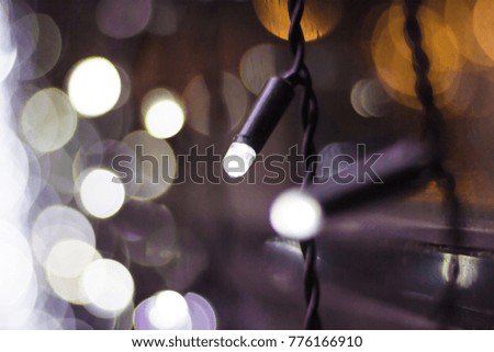 Christmas lights with bokeh. White garlands close-up
