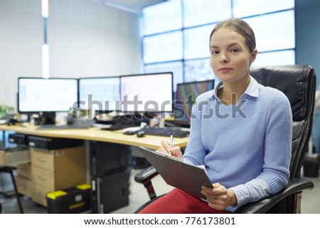 Young mining farm specialist with document signing it in workroom