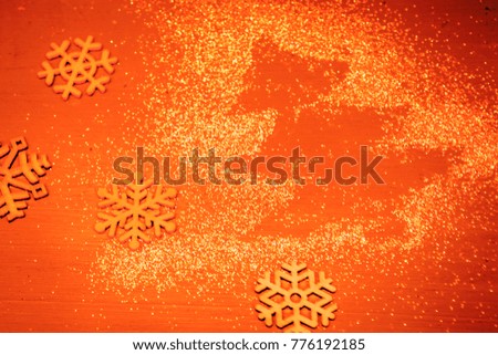 Christmas orang background with  spangles Christmas Tree  and snowfkakes