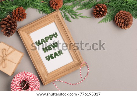 Happy New Year. Gift boxes collection wrapped in kraft paper and blank photo frame for text.