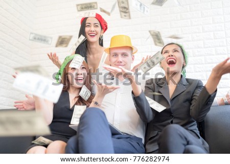 In selective focus of Group of Beautiful women in the rain of money With A handsome rich man. Money Party Concept.